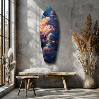 Celestial Dreamer glass wall art displayed on gray wall above wooden bench, showing woman's face surrounded by colorful clouds and stars in warm orange and cool blue tones.