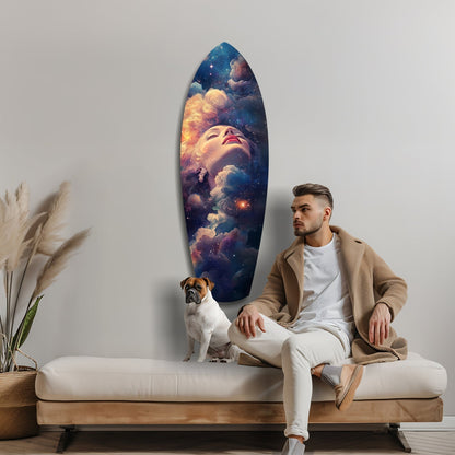 Man and dog sit on a cream bench beside an oval glass wall art depicting a woman's face surrounded by cosmic clouds and stars.