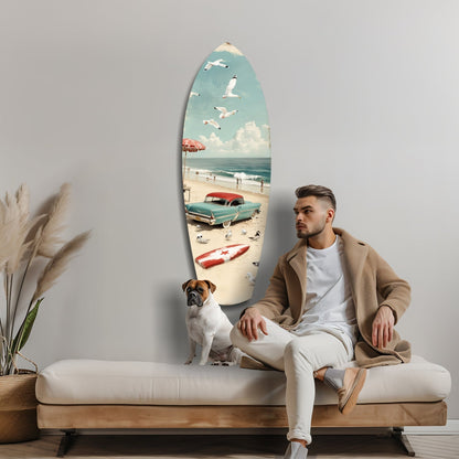 Man and dog sitting on beige sofa beside surfboard-shaped glass art depicting vintage beach scene with turquoise car and seagulls.