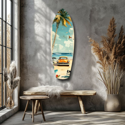 Surfboard-shaped glass wall art depicting a vintage orange car on a beach with palm tree and turquoise sky, displayed in a minimalist room setting.