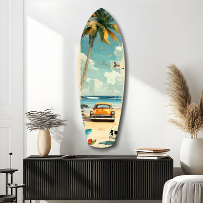 Surfboard-shaped glass art depicting vintage car, palm tree, and beach scene mounted on white wall above black cabinet with decorative vases.