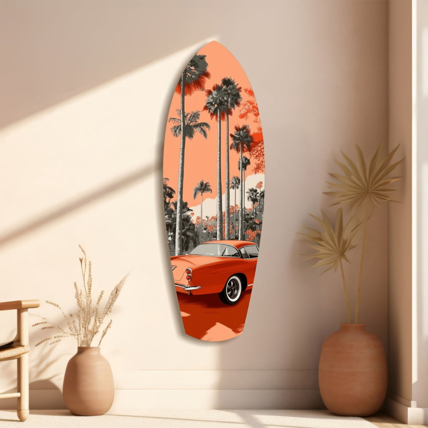 Surfboard-shaped glass wall art featuring a red vintage car and palm trees against an orange sky, displayed on a beige wall with decorative vases.