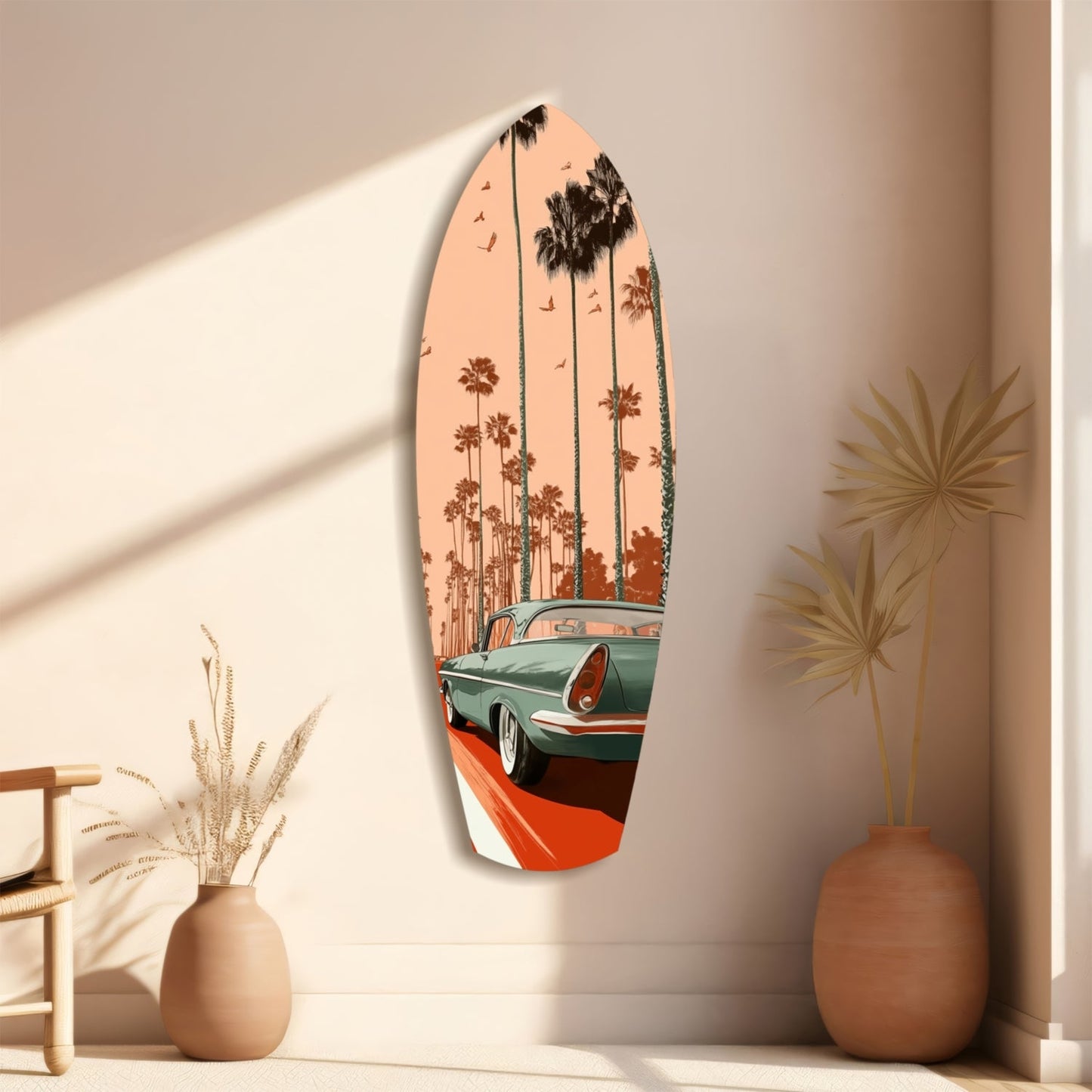 Surfboard-shaped glass wall art depicting a turquoise vintage car and palm trees against a peachy sunset sky, displayed on a beige wall with decorative vases.