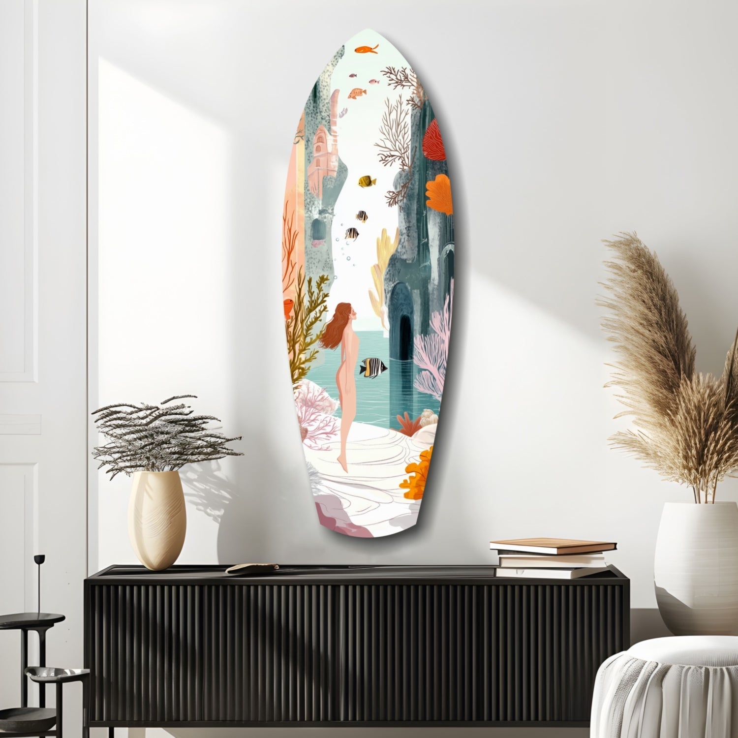 Oval glass wall art depicting an underwater scene with a woman, colorful fish, coral, and seaweed in pastel tones, displayed above a black ridged console table.