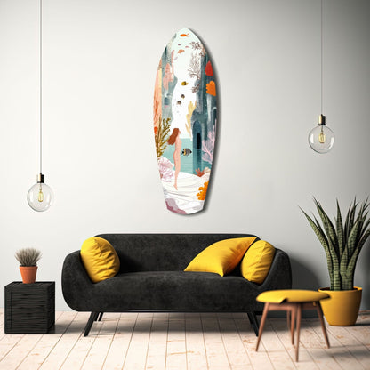 Colorful glass wall art depicting an underwater seashore scene with a figure, coral, and fish, displayed above a black sofa with yellow pillows in a modern interior setting.