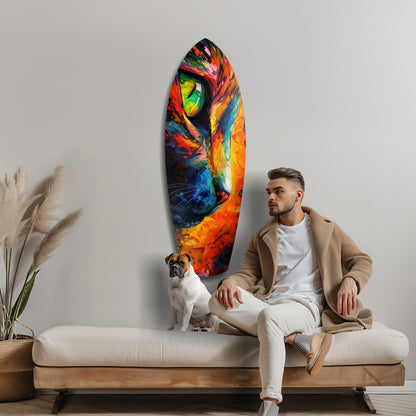 Man in neutral clothing sits on bench next to dog, gazing at colorful glass wall art featuring vibrant cat face in oranges, reds, and blues.