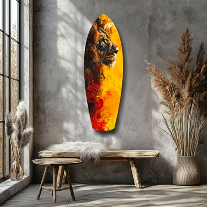 Lion Pride V2 glass wall art featuring lion profile against yellow-to-red gradient background, displayed on gray textured wall beside wooden bench and dried pampas grass.