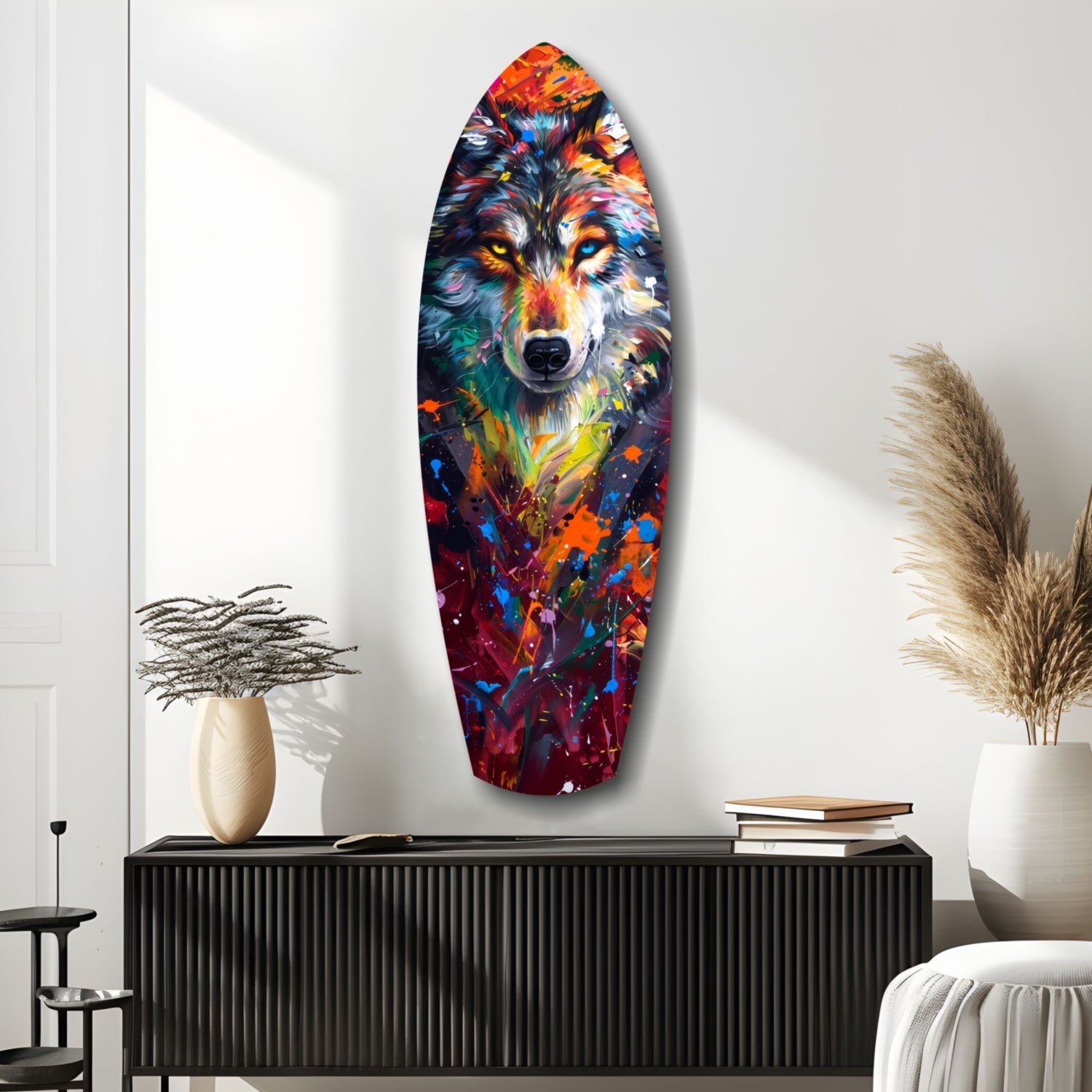 Colorful wolf head glass art displayed vertically on white wall above black cabinet with decorative plants and books.
