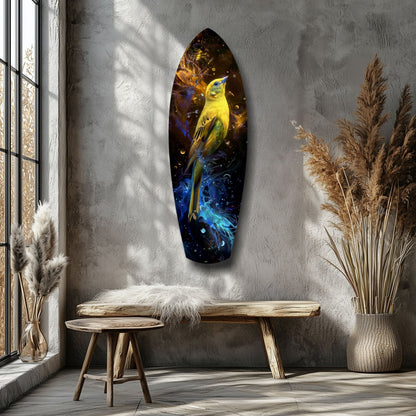 Yellow bird glass wall art with blue and gold cosmic background displayed on gray wall above wooden bench in minimalist room setting.
