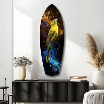 Yellow and blue glass wall art featuring a bird in flight, mounted on white wall above black credenza with decorative vases and books.