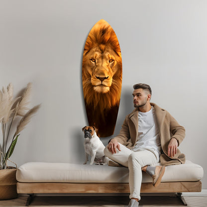 Man and small dog sitting on cream sofa beside oval glass wall art featuring majestic lion's head in golden tones.