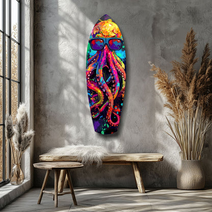 Colorful glass wall art of a smiling octopus wearing sunglasses, displayed above a wooden bench in a minimalist room with pampas grass.