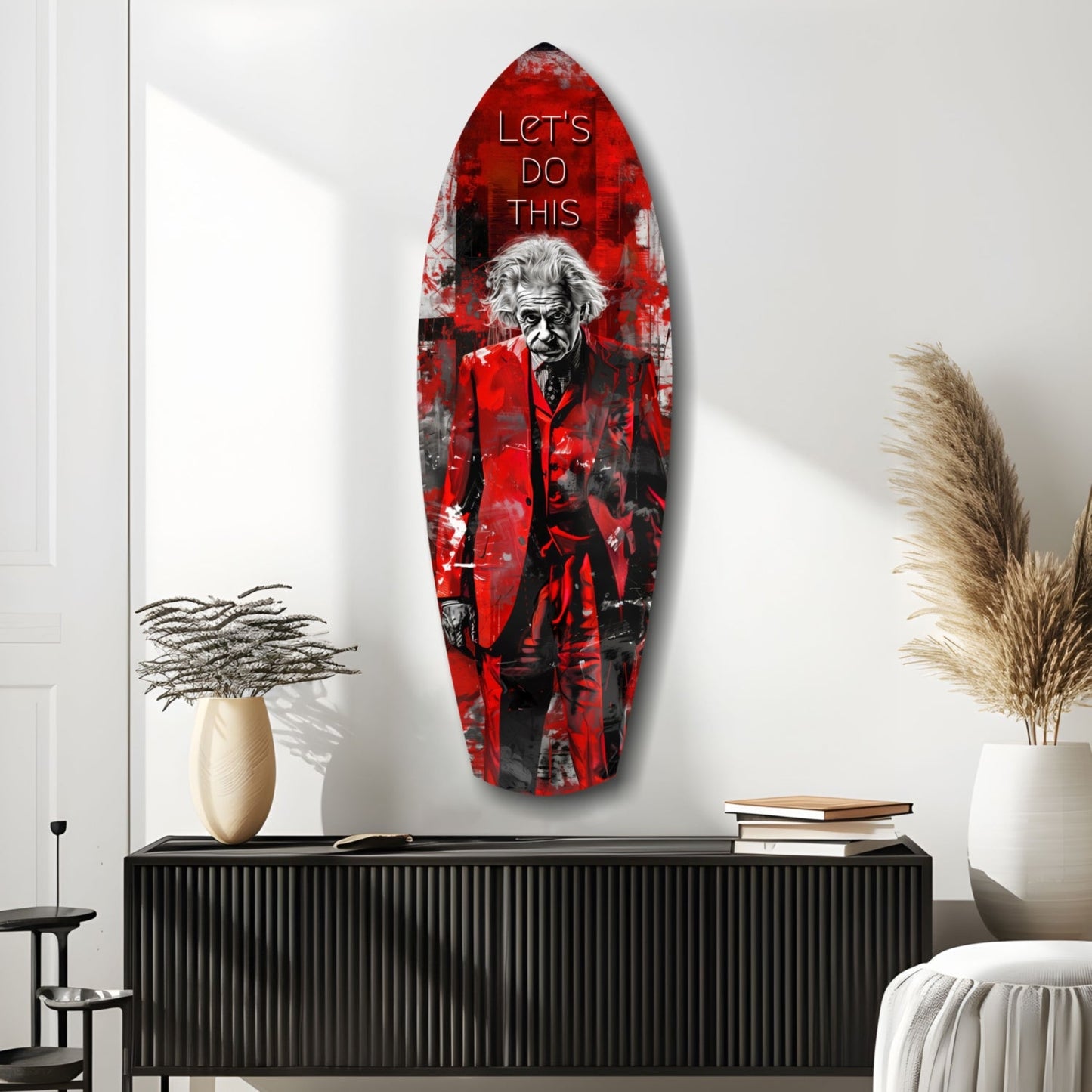 Red and black glass surfboard-shaped wall art featuring a man in red coat with "LET'S DO THIS" text, displayed above black console table in modern room.