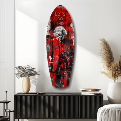 Red and black glass surfboard-shaped wall art featuring a man in red coat with "LET'S DO THIS" text, displayed above black console table in modern room.