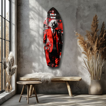 Red and black glass wall art featuring Einstein with "I Told You" text, displayed above wooden bench in minimalist interior.