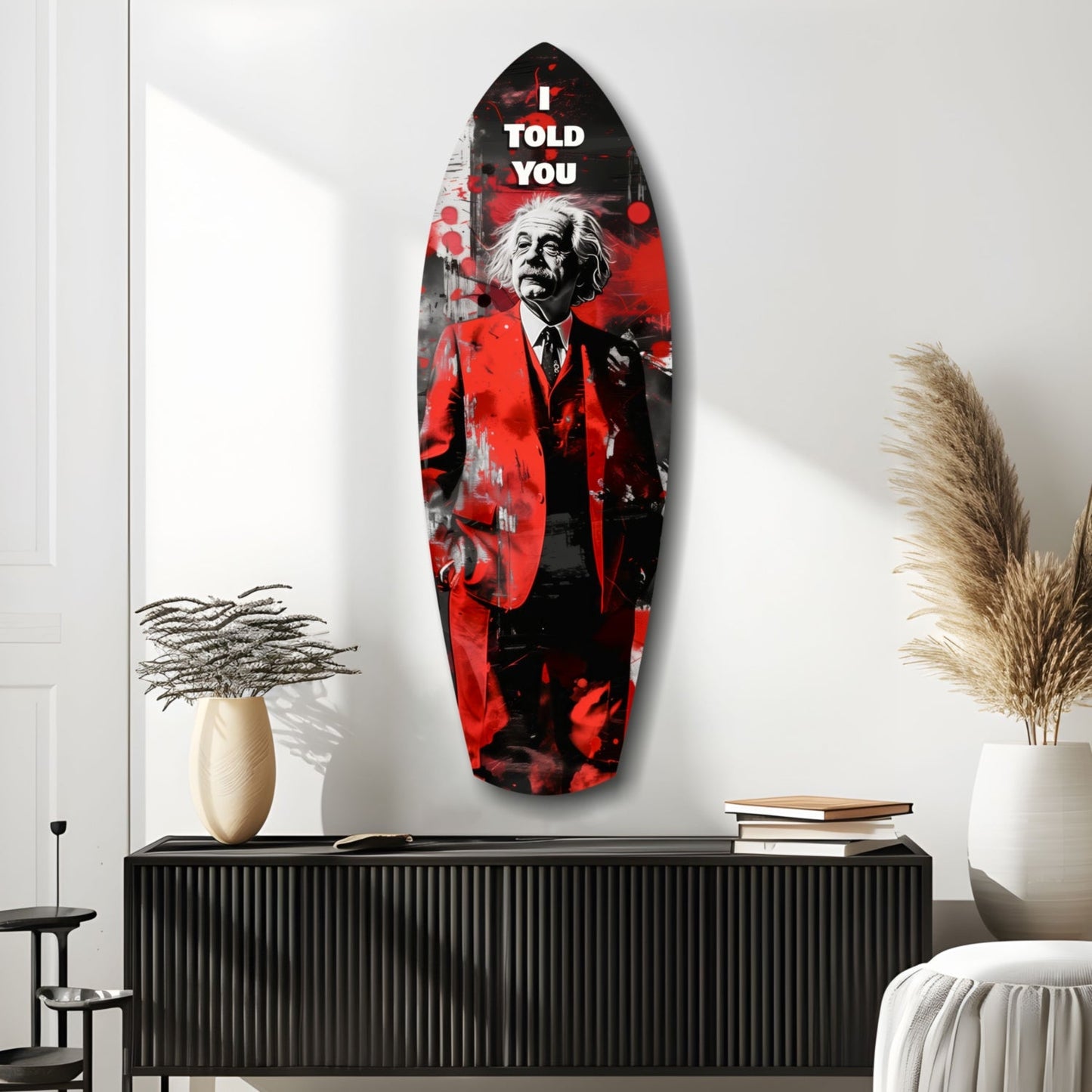 Red and black glass wall art featuring Einstein in suit with "I told you" text, displayed above black cabinet in modern interior.