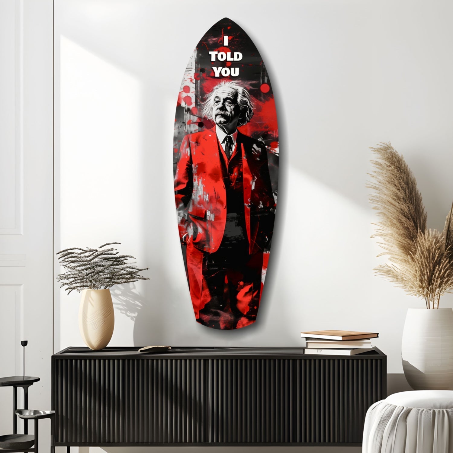 Red and black glass wall art featuring Einstein in suit with "I told you" text, displayed above black cabinet in modern interior.