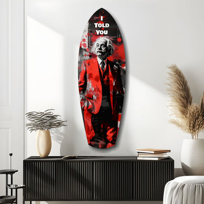 Red and black glass wall art featuring Einstein in suit with "I told you" text, displayed above black cabinet in modern interior.
