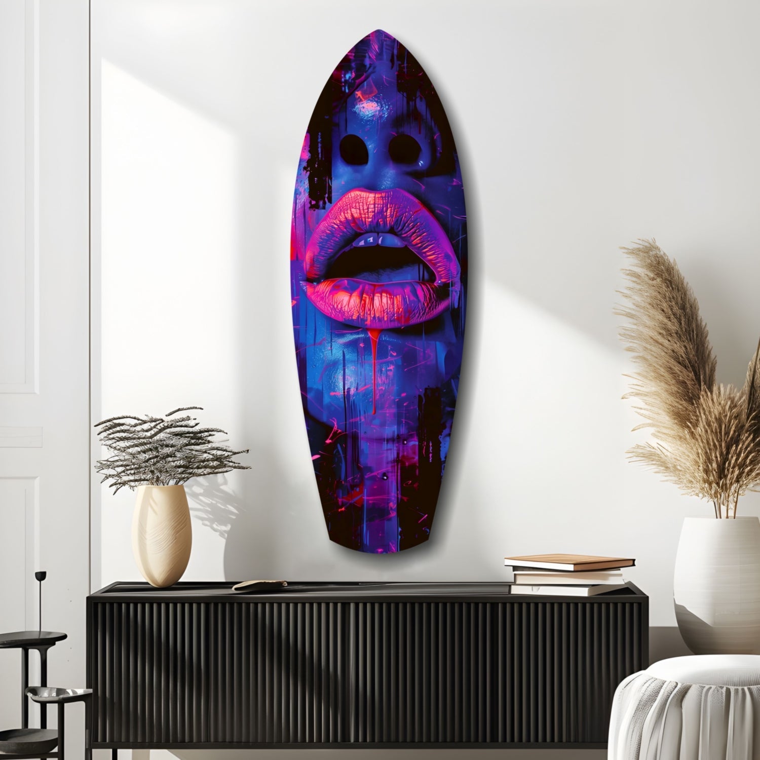 Neon pink lips with blue urban cityscape displayed on oval glass wall art mounted above black credenza in modern interior.