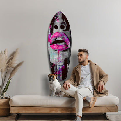 Man and dog sitting on bench beneath vibrant pink lips glass art wall piece in modern interior setting.