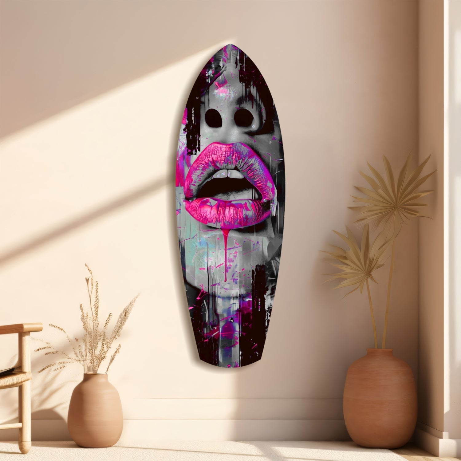 Vibrant pink lips glass wall art mounted vertically on beige wall beside terracotta vases with dried grasses.