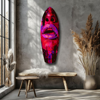 Neon pink and purple illuminated glass lips wall art mounted above wooden bench in minimalist interior with pampas grass décor.