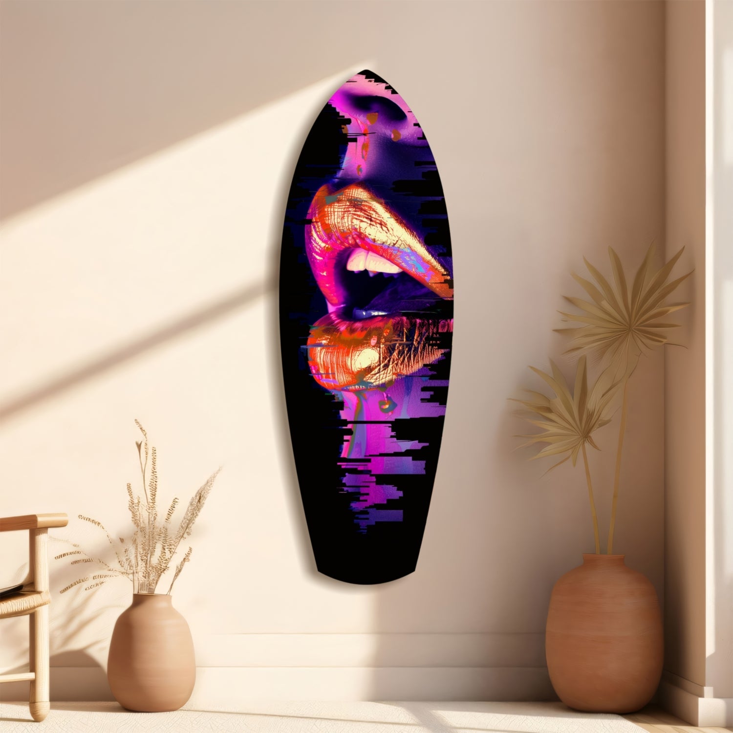 Oval glass wall art with neon pink, purple, and yellow lips on black background, displayed between two terracotta vases with dried grasses.