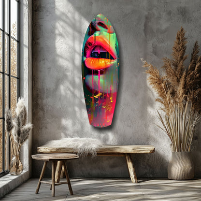 Neon lips glass wall art mounted on gray textured wall above wooden bench in minimalist room with pampas grass.