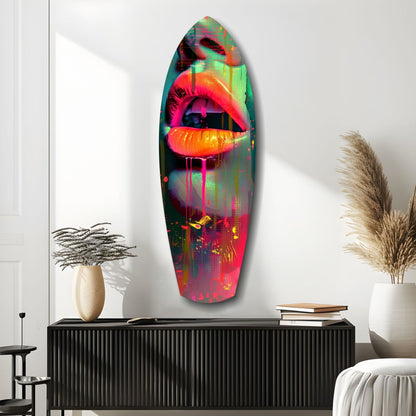 Vibrant neon lips glass wall art in pink, orange, and green tones displayed above black cabinet in modern interior setting.