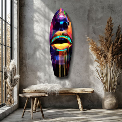 Neon lips glass wall art with vibrant rainbow colors displayed on gray wall above wooden bench in minimalist interior.