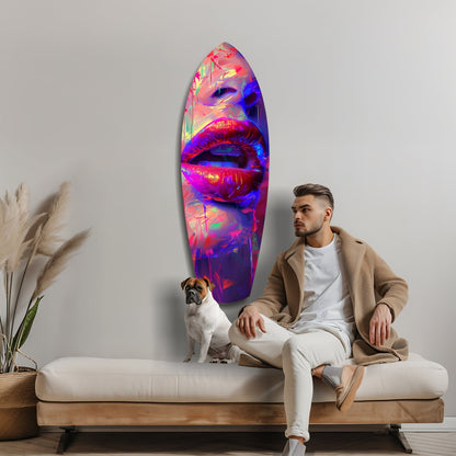 Man with dog on white sofa beside vibrant neon lips glass wall art displaying pink, blue, and yellow colors.