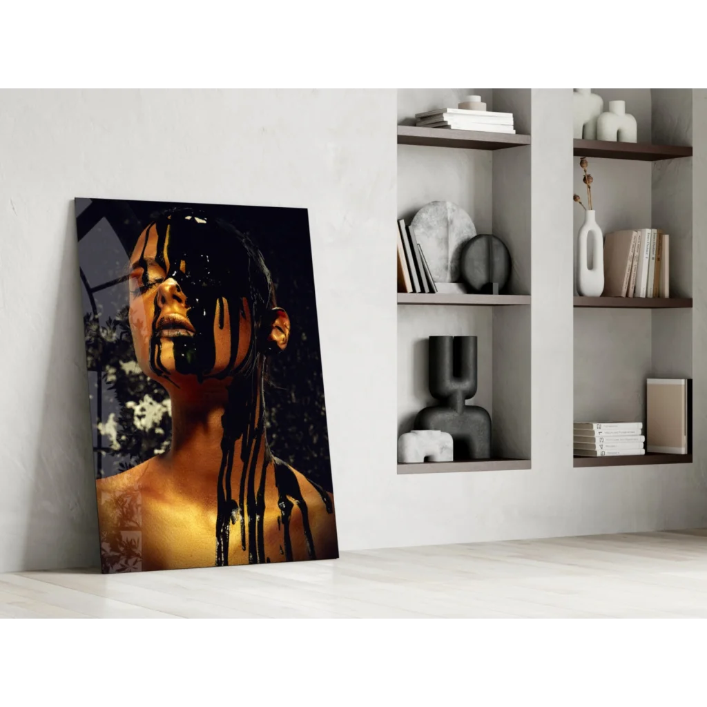 Striking black-gold glass wall art of woman with dripping liquid on face against white wall