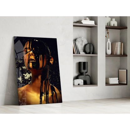 Striking black-gold glass wall art of woman with dripping liquid on face against white wall
