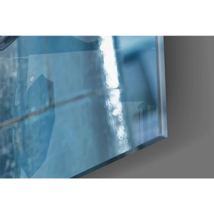 Stunning blue-tinted glass wall art with reflective glossy surface