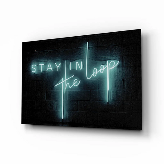 Sleek black canvas print with glowing teal neon Stay in the Loop wall art on brick wall