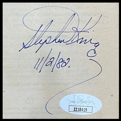 Stephen King autographed Firestarter with blue pen signature on paper