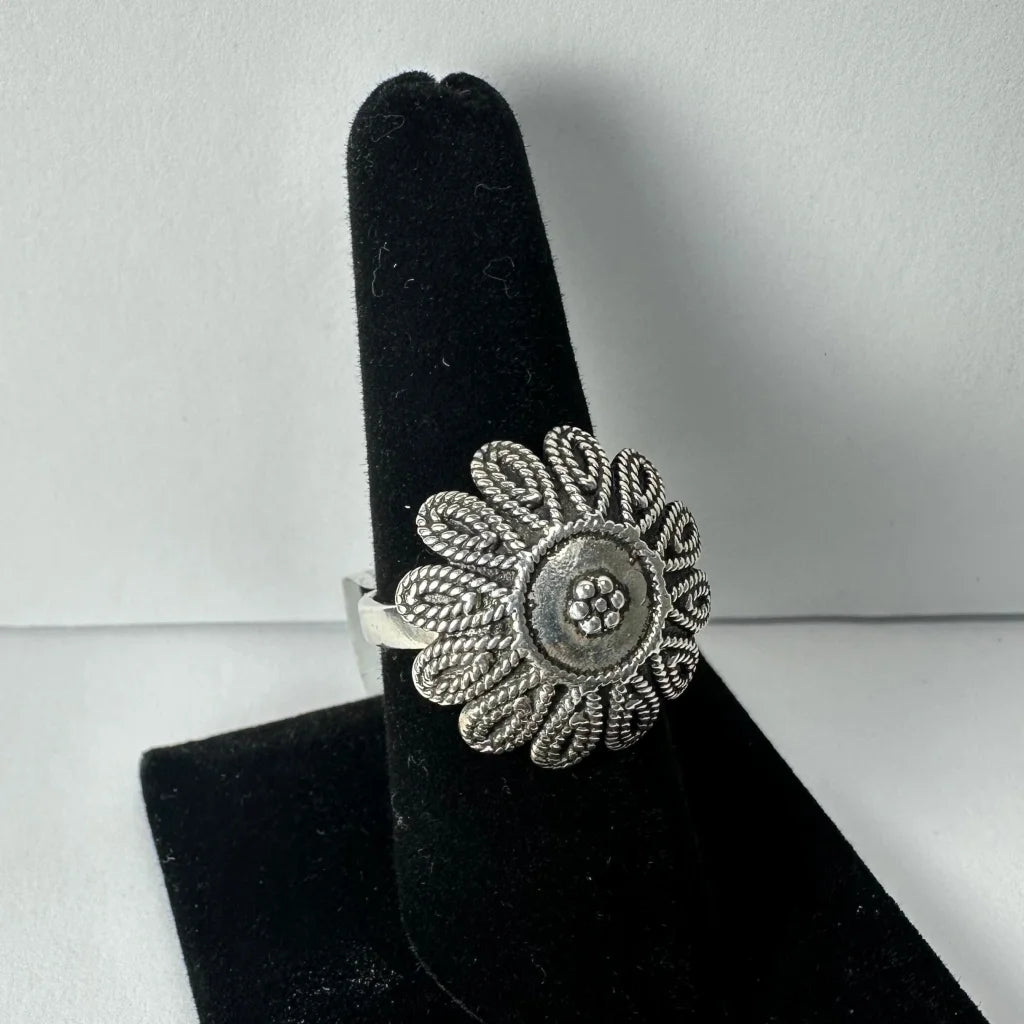Sterling silver flower ring with twisted filigree petals and embedded stones