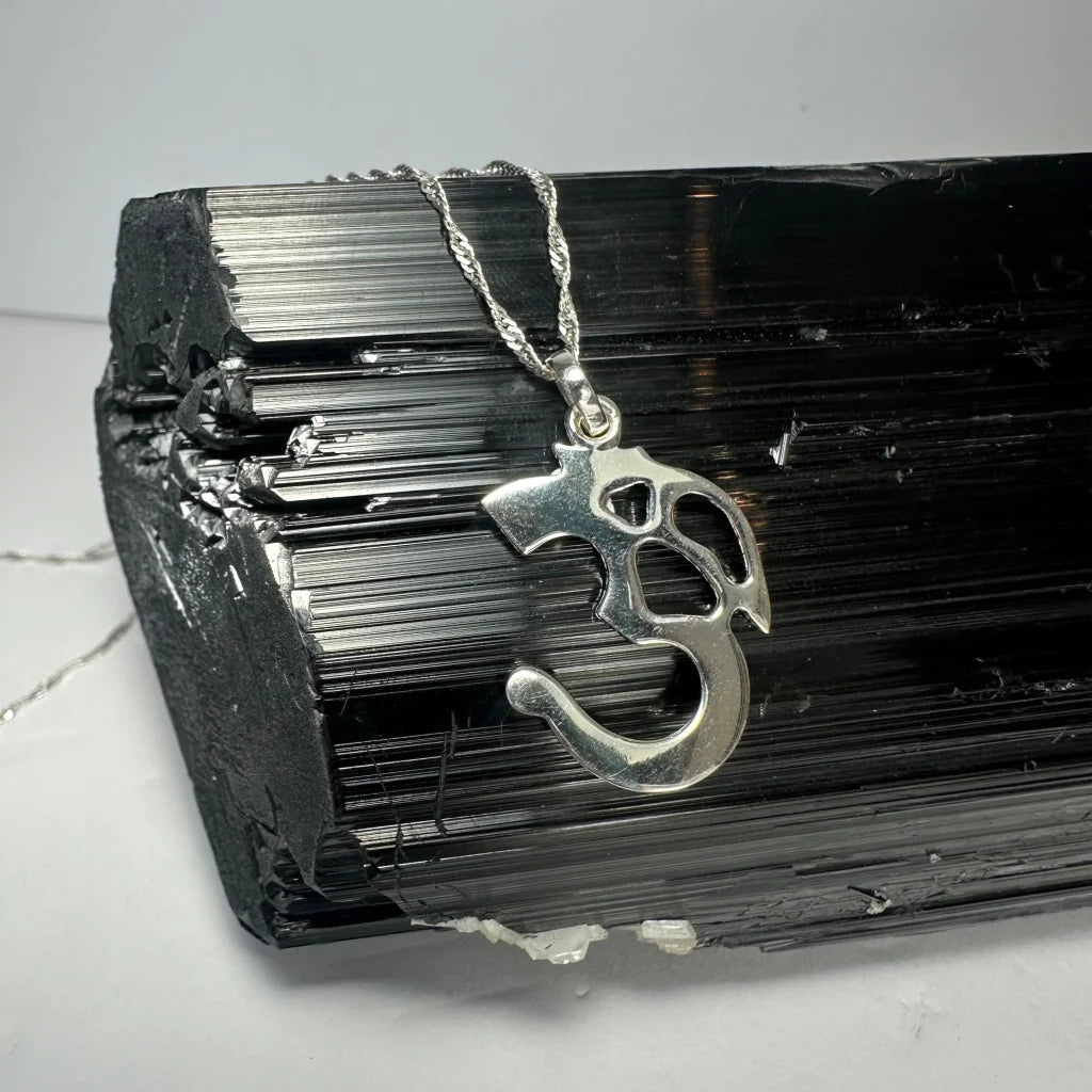 Sterling silver ohm pendant with twisted rope chain and cut-out design
