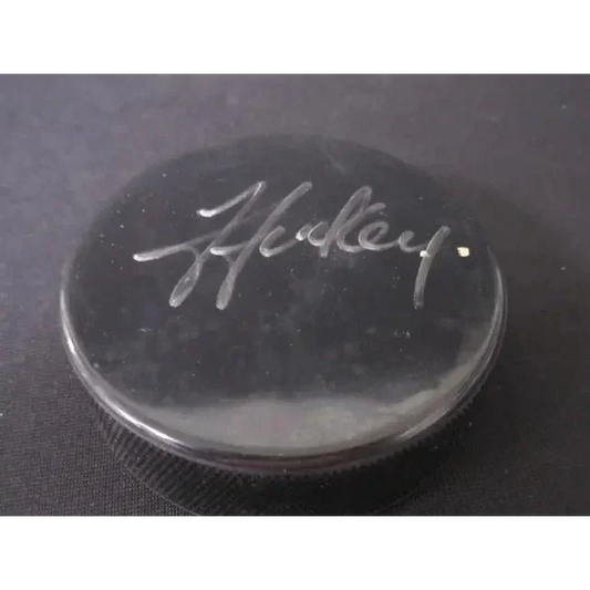 Black Steven Stamkos signed hockey puck with white signature and authentication certificate