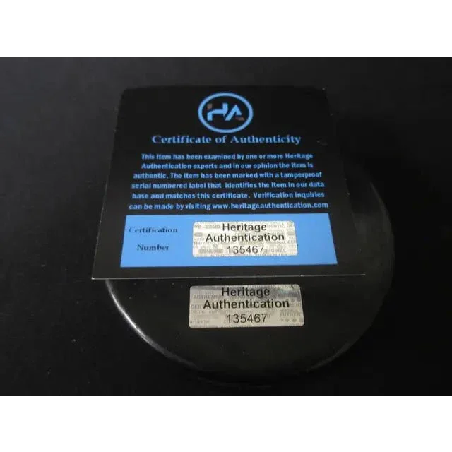 Black certificate of authenticity with Heritage sticker and serial for Steven Stamkos signed hockey puck