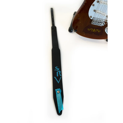 Axe Heaven® mini guitar strap with black base, teal accents, and SRV logo