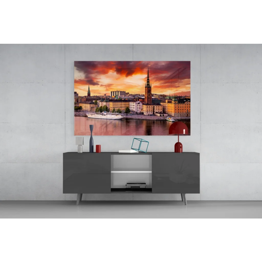 Vibrant sunset glass wall art print of cityscape with golden buildings