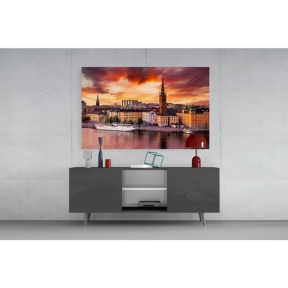 Vibrant sunset glass wall art print of cityscape with golden buildings