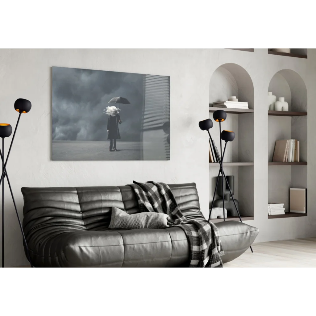 Gray leather sofa with plaid throw under Stormy Umbrella wall art