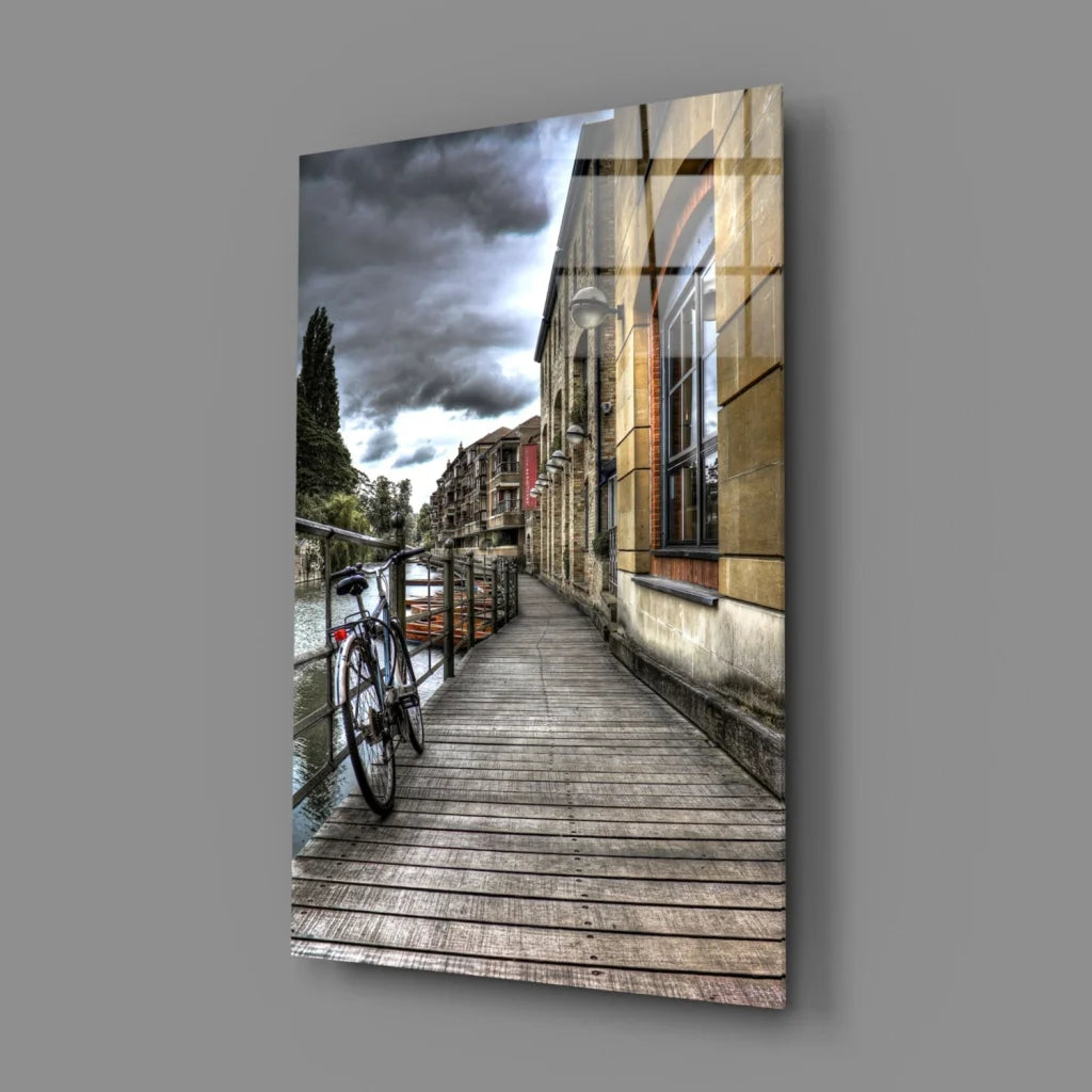 Moody urban canal glass wall art with vintage black bicycle