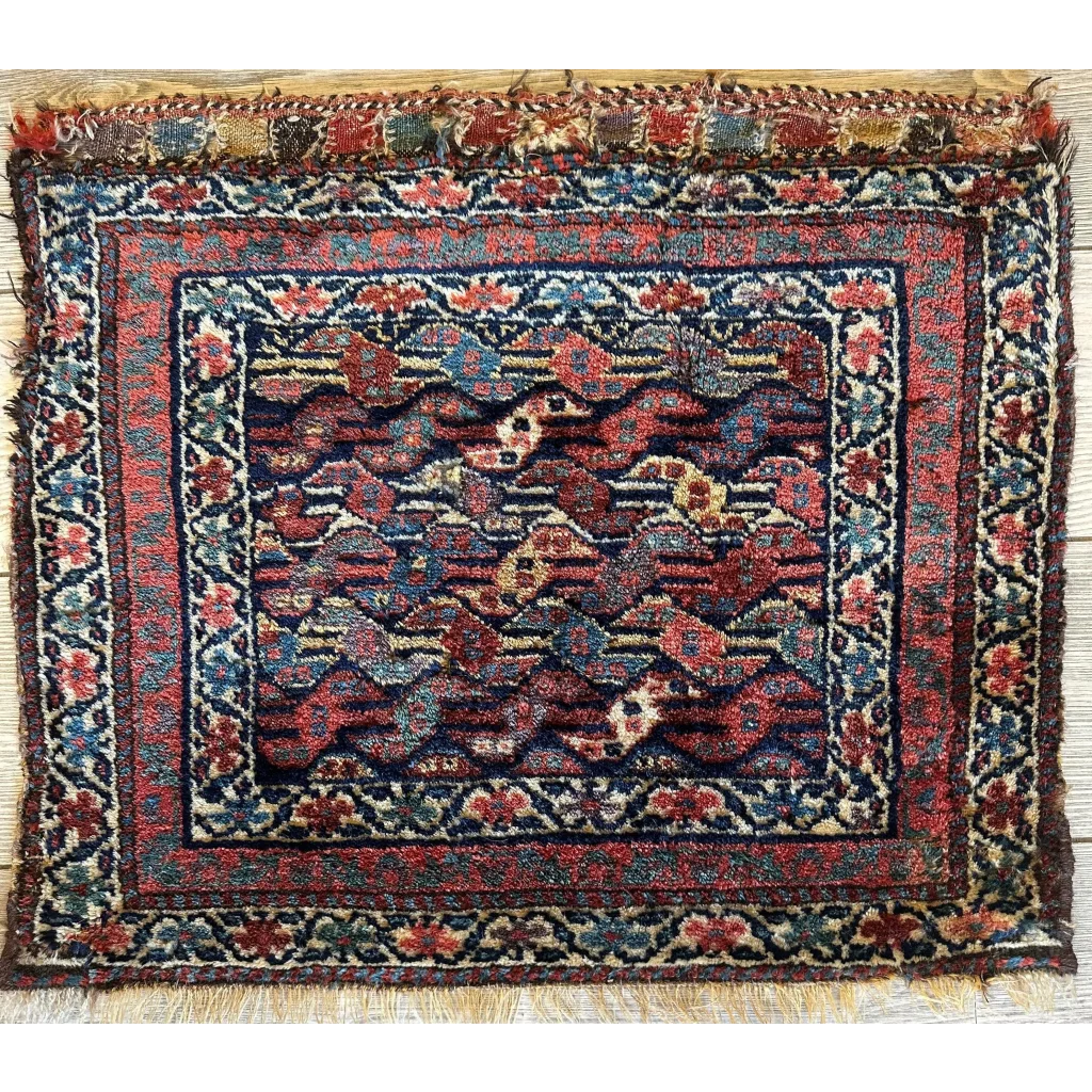 Antique 1900s Persian hanging rug, full view, intricate floral patterns in deep reds blues and gold