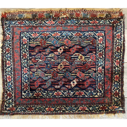 Antique 1900s Persian hanging rug, full view, intricate floral patterns in deep reds blues and gold