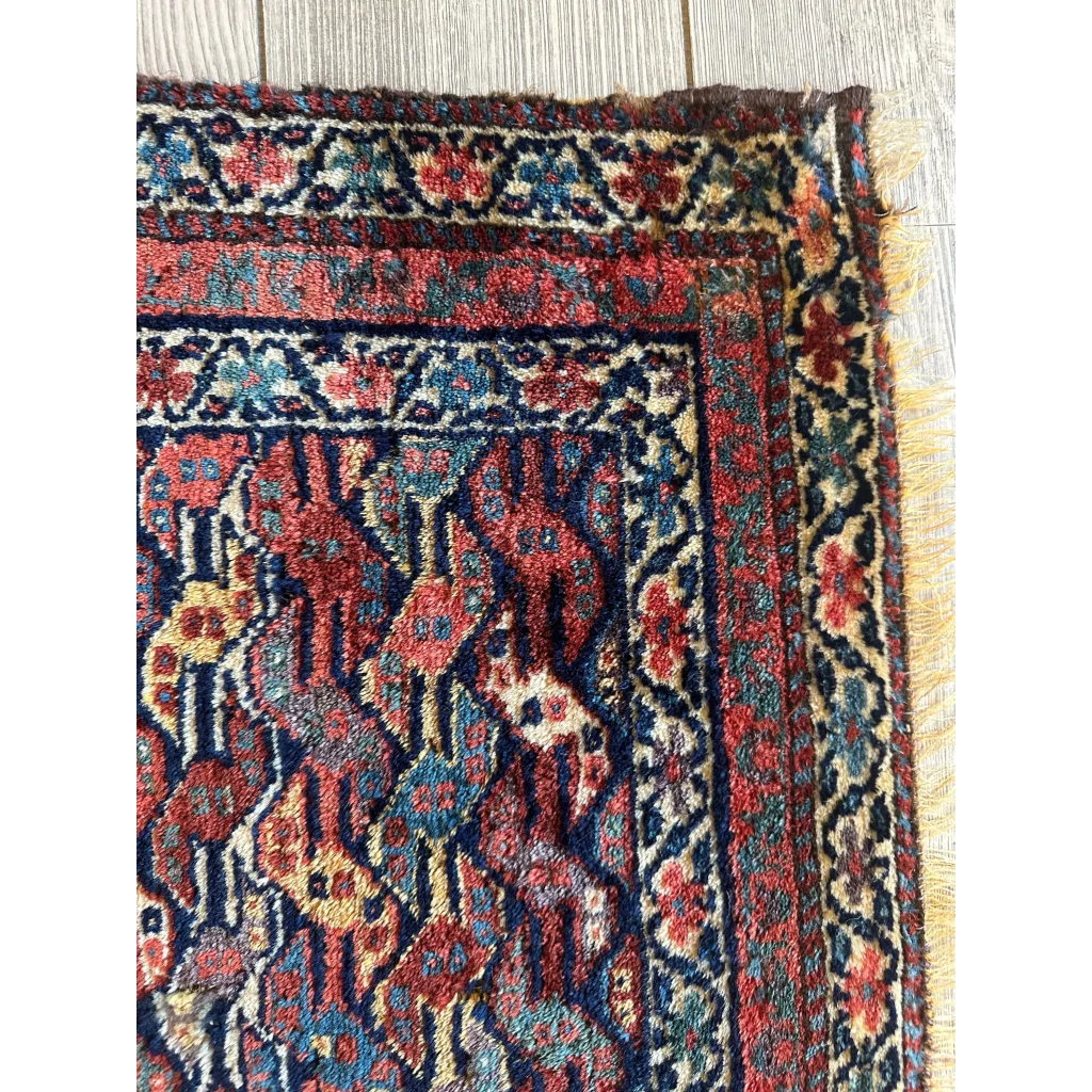 Rare 1900s Persian hanging rug, border and field detail showing geometric floral patterns, red gold