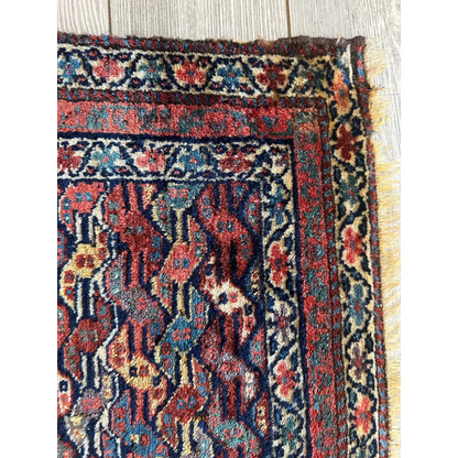 Rare 1900s Persian hanging rug, border and field detail showing geometric floral patterns, red gold
