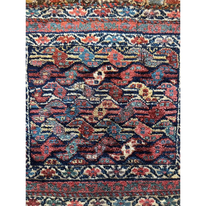 1900s Persian hanging rug, detail of intricate floral motifs in red and blue, hand-knotted wool